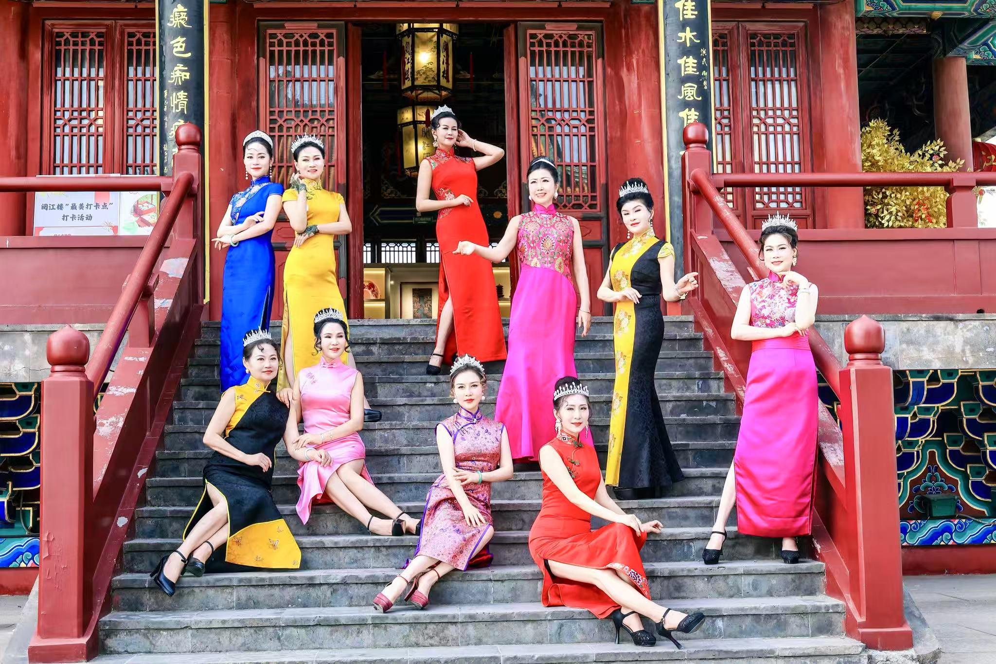 A group of women posing on stairs

Description automatically generated